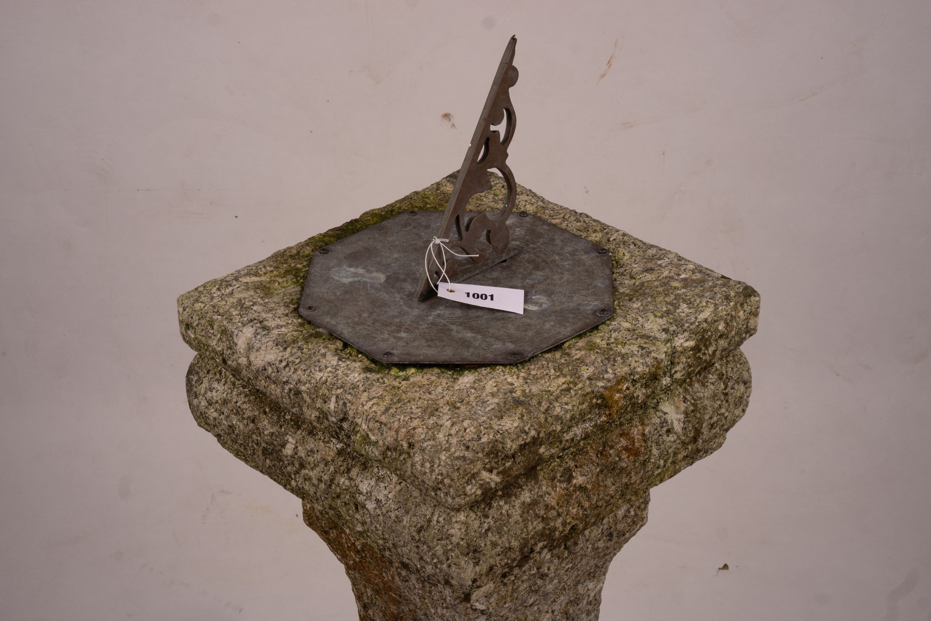 An octagonal sundial on reconstituted stone plinth, height 92cm